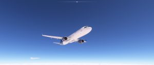A21N airliner cruises smoothly against a clear blue sky, captured from below as it glides gracefully overhead.